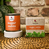 Sweet Wild sugar cabin product with packaging on a woven surface and brick wall background